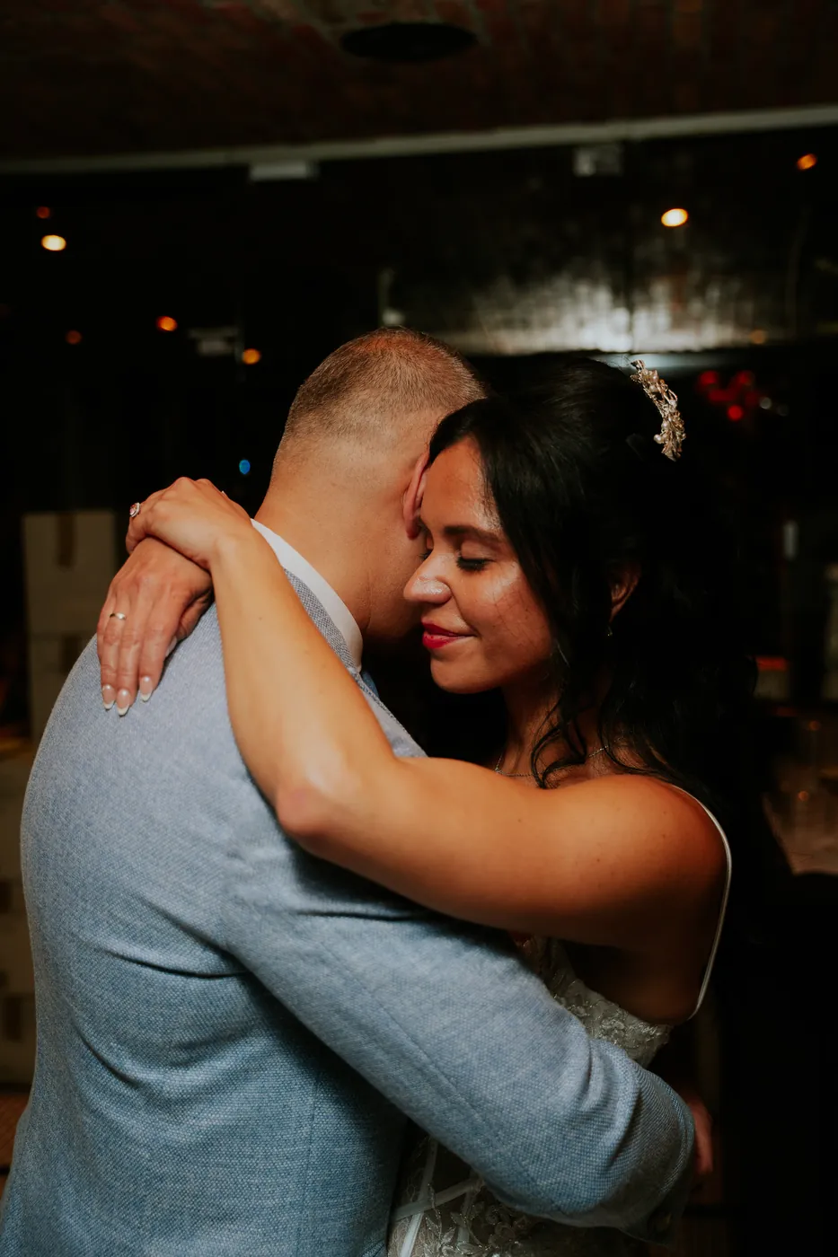Guests embracing on the dance floor at the reception.